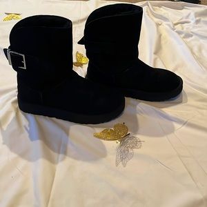 Women’s UGG boots with rhinestone buckle.